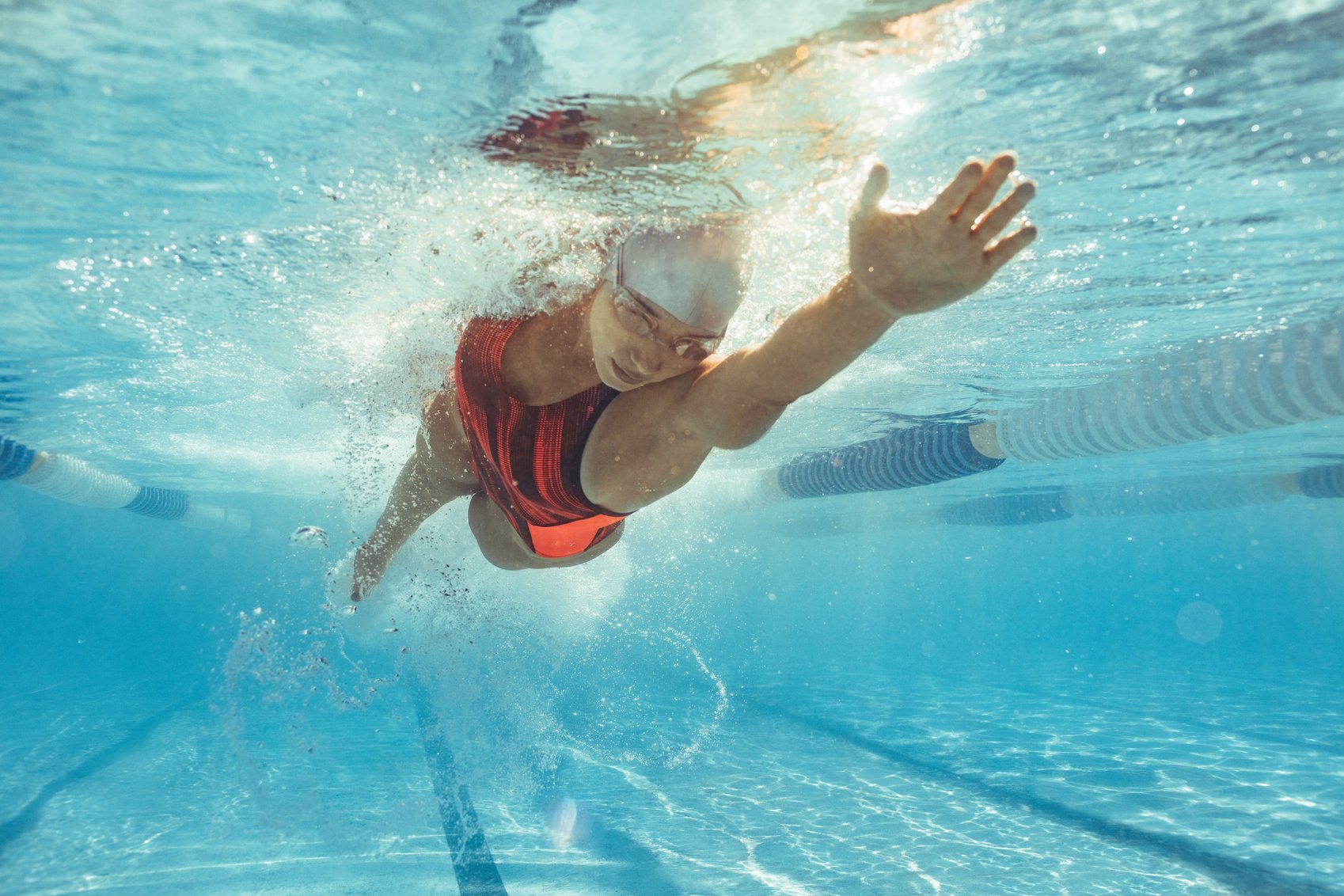 Female Athlete Swimming in Pool